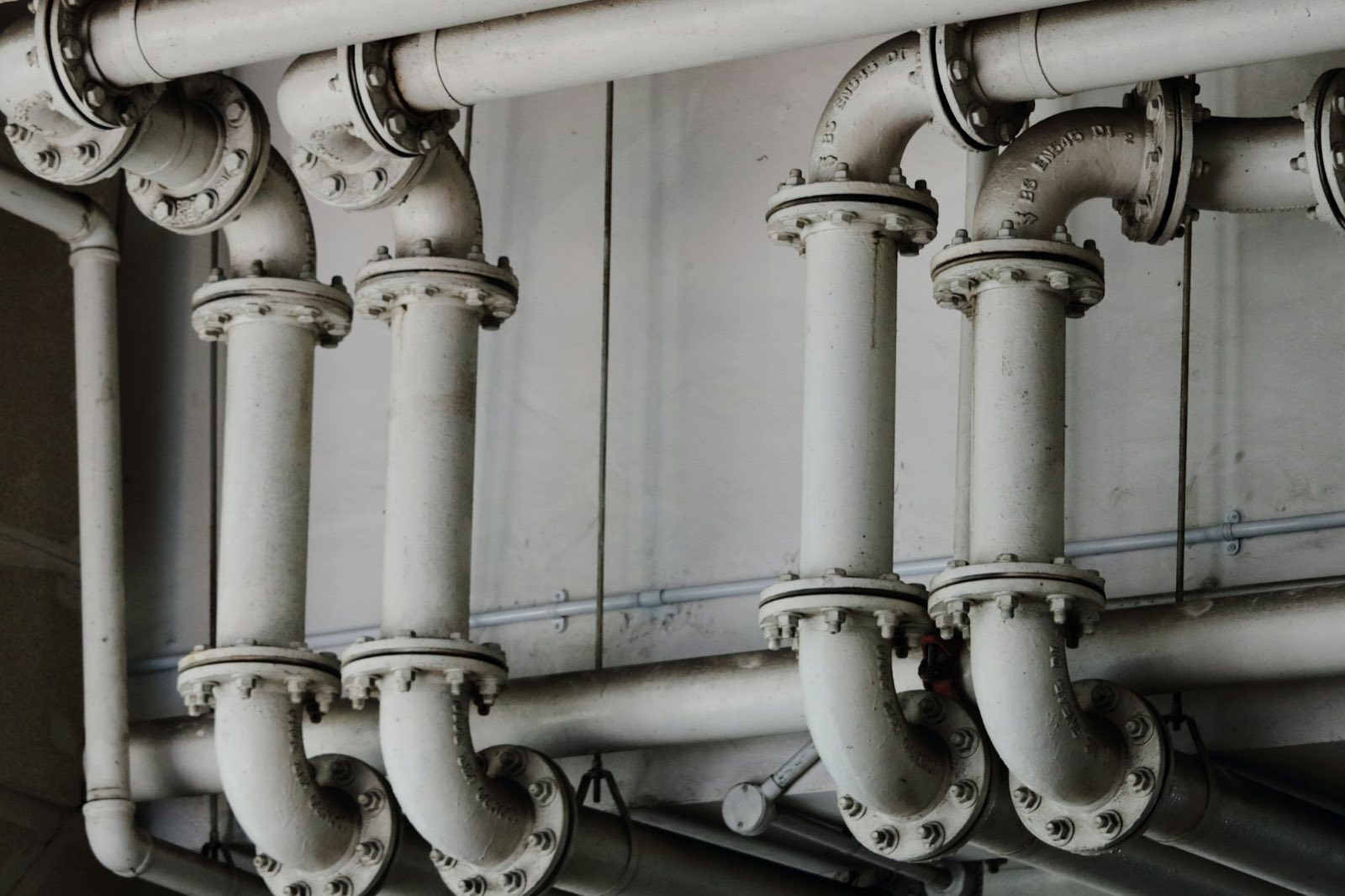 Steel pipes with flanged joints along a wall